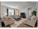 The spacious living room features a large window for natural light and a cozy rug that ties the room together at 9781 Roseberry St, Ladson, SC 29456