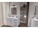Well-lit bathroom features a white vanity, medicine cabinet, modern fixtures, and an ensuite opening to a bedroom at 00 Woodland Dr, Summerville, SC 29485