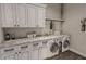 Bright laundry room with white cabinets, a folding counter, and a washer and dryer at 00 Woodland Dr, Summerville, SC 29485