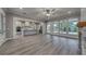Spacious living room with wood floors, a stone fireplace, lots of windows and an open floor plan at 00 Woodland Dr, Summerville, SC 29485