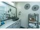 Stylish bathroom featuring granite countertop, decorative mirror, and unique basketweave wall decor at 1025 Riverland Woods Pl # 1108, Charleston, SC 29412
