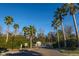 Community entrance with lush palm trees and landscaping around the entrance at 1025 Riverland Woods Pl # 1108, Charleston, SC 29412