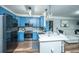 Open kitchen featuring blue cabinets, stainless appliances, and a view to the living area at 1025 Riverland Woods Pl # 1108, Charleston, SC 29412
