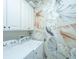 Laundry room featuring modern appliances, decorative wallpaper, and storage space at 1025 Riverland Woods Pl # 1108, Charleston, SC 29412