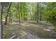 View of the backyard with trees and a brick patio area at 104 Huntington Cir, Summerville, SC 29485
