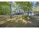 Backyard view of the home featuring the screened in porch, trees, and partial fence at 104 Huntington Cir, Summerville, SC 29485