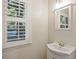 Bathroom featuring a white vanity sink, mirror, and a window with blinds at 104 Huntington Cir, Summerville, SC 29485