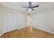 Cozy bedroom featuring hardwood floors, a ceiling fan, and a spacious closet at 104 Huntington Cir, Summerville, SC 29485