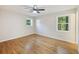 Sunlit bedroom with hardwood floors and large windows overlooking lush greenery at 104 Huntington Cir, Summerville, SC 29485