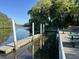 A community dock with picnic tables, a walkway, and beautiful waterfront views on a sunny day at 104 Huntington Cir, Summerville, SC 29485
