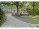 View of the home featuring a driveway, mature trees, a well manicured yard, and a brick and siding exterior at 104 Huntington Cir, Summerville, SC 29485