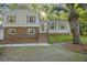 Charming home featuring brick accents, light gray siding, green shutters, and a well manicured yard at 104 Huntington Cir, Summerville, SC 29485