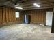 Unfinished garage featuring a brick foundation, framed walls, concrete floor, and lighting at 104 Huntington Cir, Summerville, SC 29485