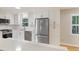 Modern kitchen featuring white cabinets, stainless steel appliances, lots of natural light, and a quartz countertop at 104 Huntington Cir, Summerville, SC 29485