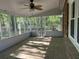 Back porch with brick flooring, screened in windows and view of the wooded yard at 104 Huntington Cir, Summerville, SC 29485