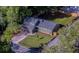 Aerial view of a well-maintained property with lush greenery, a fenced-in backyard, and a long driveway at 1049 Bradford Ave, Charleston, SC 29412