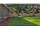 Home's backyard with a lush lawn, wooden deck, and mature trees providing shade at 1049 Bradford Ave, Charleston, SC 29412