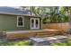 Backyard showcasing a wooden deck and patio, complemented by green grass and a privacy fence at 1049 Bradford Ave, Charleston, SC 29412