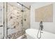 Luxurious bathroom showcasing a glass-enclosed shower with marble tile and a modern freestanding tub at 1049 Bradford Ave, Charleston, SC 29412