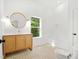 Bathroom featuring a modern vanity, decorative mirror, and bathtub with tiled walls at 1049 Bradford Ave, Charleston, SC 29412