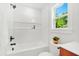 Bright bathroom features white subway tile, modern fixtures, and a window offering a green view at 1049 Bradford Ave, Charleston, SC 29412