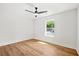 Bright bedroom with wood floors, ceiling fan, and a large window offering ample natural light and neighborhood view at 1049 Bradford Ave, Charleston, SC 29412