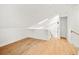Loft-like bonus room showcases wood floors, white walls, and skylight at 1049 Bradford Ave, Charleston, SC 29412