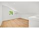 A light-filled bonus room features wood floors and a window with a leafy view at 1049 Bradford Ave, Charleston, SC 29412