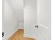 Small storage closet with wood floor and a white door, offers practical space at 1049 Bradford Ave, Charleston, SC 29412