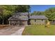 Charming home exterior with manicured lawn, inviting curb appeal, and a two-car garage at 1049 Bradford Ave, Charleston, SC 29412