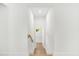 Hallway with white walls and hardwood floors leading to additional rooms in the home at 1049 Bradford Ave, Charleston, SC 29412