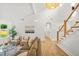 Bright living room boasts a high ceiling, hardwood floors, and modern stairs at 1049 Bradford Ave, Charleston, SC 29412