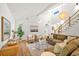 Bright living room featuring hardwood floors, modern lighting, and a comfortable seating arrangement near a staircase at 1049 Bradford Ave, Charleston, SC 29412