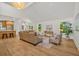 Open-concept living area boasting hardwood floors, abundant natural light, and a cozy sofa with stylish accent chairs at 1049 Bradford Ave, Charleston, SC 29412
