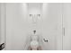 A pristine white powder room is decorated with a modern toilet, towel rack, and accent plant at 1049 Bradford Ave, Charleston, SC 29412