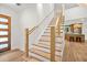 Beautiful staircase with modern railings, wood treads, and natural light flowing from windows at 1049 Bradford Ave, Charleston, SC 29412