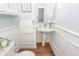 Stylish powder room with pedestal sink, framed mirror and white wainscoting at 105 Kirkhaven Ct, Goose Creek, SC 29445