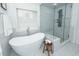 Modern bathroom with a free-standing tub, walk-in glass shower, stool and marble tiled floor, with natural light at 105 Kirkhaven Ct, Goose Creek, SC 29445