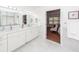 Bathroom featuring double vanity, framed mirrors, marble counters and floors, white cabinets and a decorative vase at 105 Kirkhaven Ct, Goose Creek, SC 29445