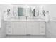 Elegant white bathroom with marble floors, double vanity, framed mirrors, and an open doorway to a bedroom at 105 Kirkhaven Ct, Goose Creek, SC 29445