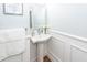 Bright powder room with a white pedestal sink and classic white trim and fixtures at 105 Kirkhaven Ct, Goose Creek, SC 29445