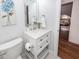 Bright bathroom with a modern vanity, marble countertop, and an open view to another tastefully decorated bedroom at 105 Kirkhaven Ct, Goose Creek, SC 29445