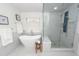 Modern bathroom features free standing tub, window, marble floors and an adjacent glass shower with built in bench seating at 105 Kirkhaven Ct, Goose Creek, SC 29445