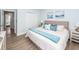 Bright bedroom with wood floors, with a large bed and a clear view into another room at 105 Kirkhaven Ct, Goose Creek, SC 29445