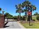 Gated entrance to Lamb's Gate Community, framed by palm trees and lush greenery at 105 Kirkhaven Ct, Goose Creek, SC 29445
