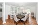 Elegant dining room features hardwood floors, built-in shelving, and a modern chandelier at 105 Kirkhaven Ct, Goose Creek, SC 29445