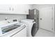 Well-equipped laundry room with modern washer and dryer on white tile floor at 105 Kirkhaven Ct, Goose Creek, SC 29445
