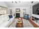 Bright living room with fireplace, hardwood floors, and a white leather couch at 105 Kirkhaven Ct, Goose Creek, SC 29445