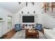 Comfortable living room with hardwood floors, a built-in entertainment center, and stylish chairs at 105 Kirkhaven Ct, Goose Creek, SC 29445