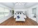 Large bedroom with tray ceiling, hardwood floors, and ensuite bath at 105 Kirkhaven Ct, Goose Creek, SC 29445
